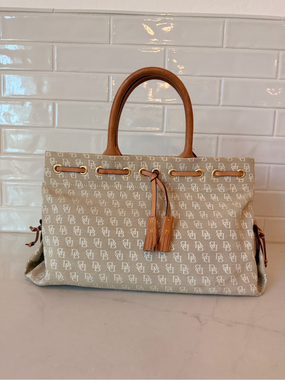 Dooney & Bourke tassel tote with brown leather handles